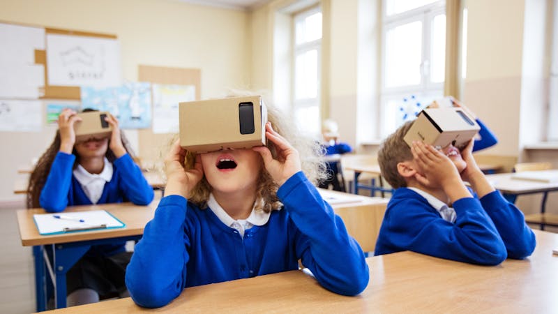 elementary kids looking through a virtual tour device